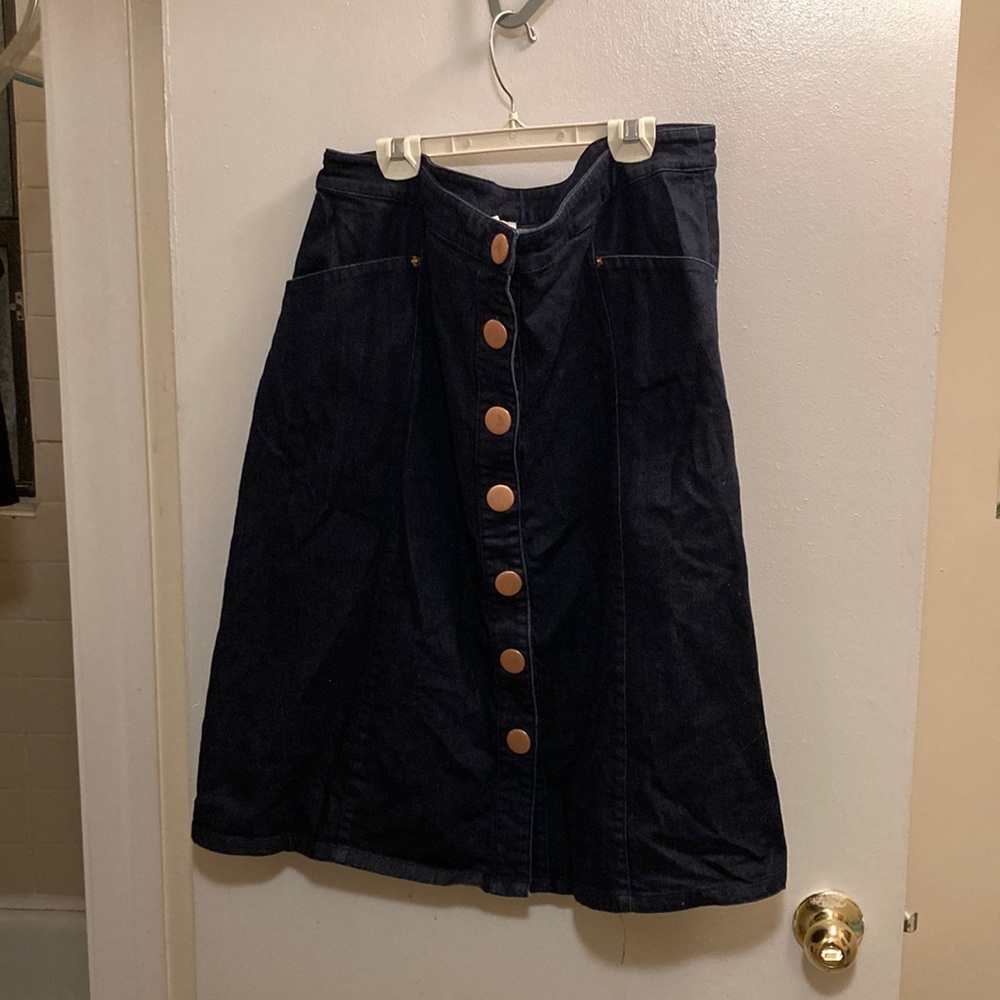 Denim Modcloth skirt with front and back pockets. Falls below knee.